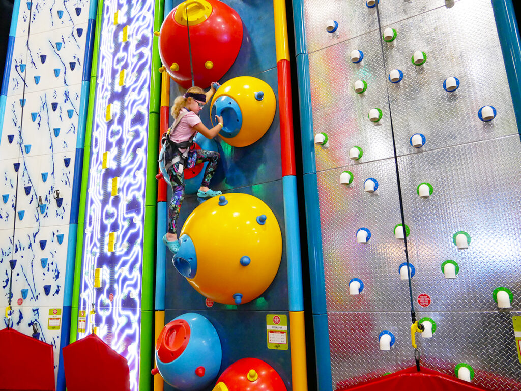 young girl rock climbing